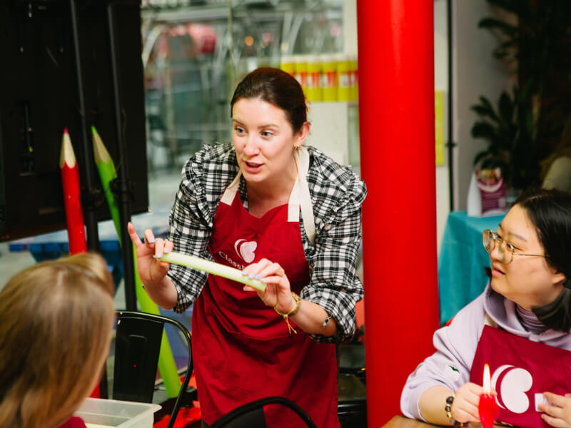 Harri Price, owner of Habit Haus, teaches a Bendy Boy candle making class to students